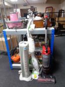 A tower fan together with a Morphy Richards steam mop and a Vax upright vacuum