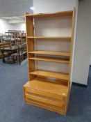 A set of pine open bookshelves fitted two drawers beneath.