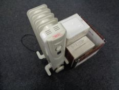 Three boxes of Johnson's glazed wall tiles together with an oil filled radiator