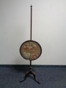 A 19th century mahogany tapestry pole screen.
