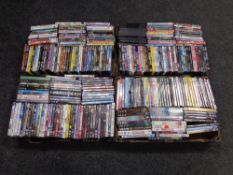 Four boxes containing assorted DVDs.