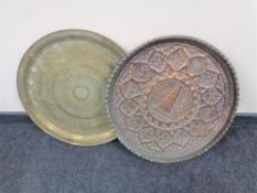 A circular Eastern brass wall plaque together with a further copper wall plaque
