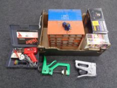 A box of two metal multi drawer storage chests containing hardware together with Halfords battery