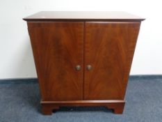 An inlaid mahogany double door storage cabinet,