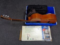 A crate containing Spanish acoustic guitar, laptop bag, mini dehumidifier etc.