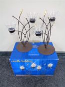 A pair of boxed Enigma metal and glass two-way candle holders