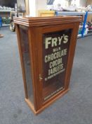 A wall mounted display cabinet bearing later Fry's Chocolate advertisement