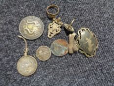 A Chinese Yun-Nan-Province coin, together with a Siam silver brooch, 1964 American half dollar,