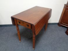 A Victorian mahogany flap sided table fitted a drawer