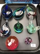 A tray containing eight glass paperweights to include teardrop shaped examples.