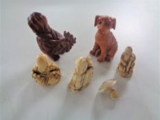 A box containing carved bone and fruit wood netsukes.