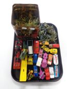 A tray containing 20th century die cast Matchbox play worn vehicles together with a tin containing
