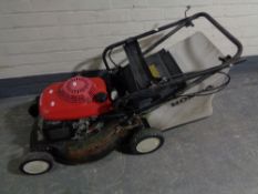 A Honda ECO petrol lawn mower.