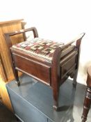 An antique mahogany adjustable storage piano stool