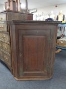 An early 19th century hanging corner cupboard
