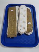 A tray containing a quantity of antique brass and china finger plates.