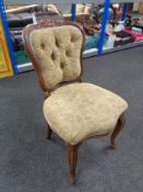 A beech framed French occasional chair upholstered in floral fabric on cabriole legs