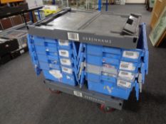 Two plastic dollies together with eight blue plastic storage crates