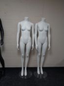 Two female mannequins on stands (white).