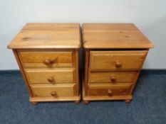 A pair of pine three drawer bedside chests