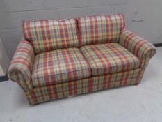A Delcor bed settee in checkered fabric