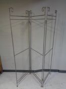 A metal three way folding room divider