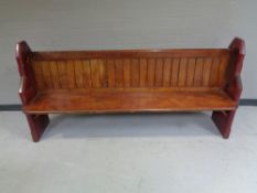 A stained pitch pine church pew,