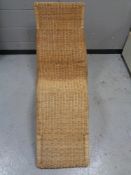 A wicker lounger chair