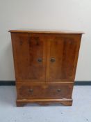 An inlaid yew wood double door cabinet