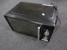 A Russell Hobbs microwave together with a Vax vacuum.