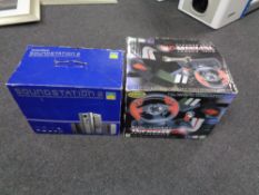 A boxed PlayStation 2 sound station together with a boxed Logic 3 top drive computer steering wheel.