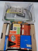 Two boxes of vintage film reels and projector slides