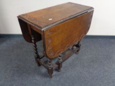 A carved oak barley twist gateleg table