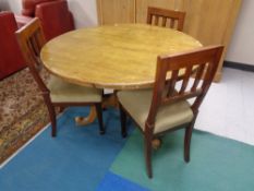 A circular pine pedestal table