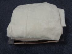 A box of two pairs of cream patterned curtains