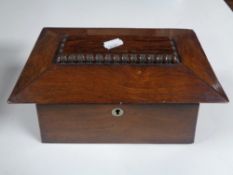 A Victorian rosewood tea caddy