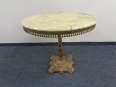 A circular onyx bar table on cast iron base,