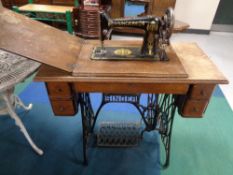 A Singer treadle sewing machine in oak table