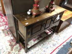 A Chapman's Siesta oak double door cabinet on raised legs
