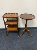 A mahogany three tier occasional stand together with a mahogany wine table