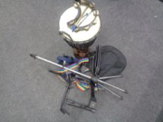 A drum, four various guitar/instrument stands, a soft carry case for a mandolin, guitar straps,