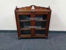 An Edwardian mahogany Arts and Crafts wall cabinet