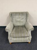 A contemporary wingback armchair