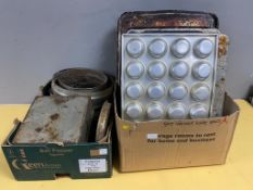Two boxes containing a large quantity of stainless steel and aluminium oven trays, muffin trays,