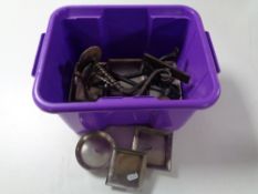 A plastic tub of assorted metal candle holders