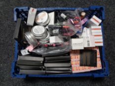 A box containing a large quantity of assorted makeup to include lip glosses, shea butter,