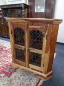 A sheesham wood double door corner cabinet