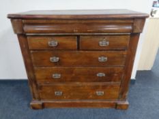 An Edwardian stained pine six drawer chest