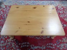 A stripped pine low coffee table