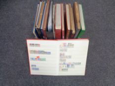 A box containing folders and albums of stamps of the world.